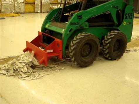 Floor tile removal with a skid steer scraper attachment